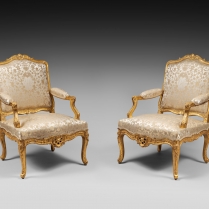 Four carved and gilded armchairs